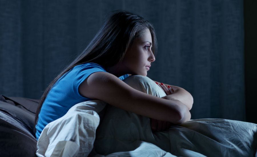 Photo of a woman sitting up in bed