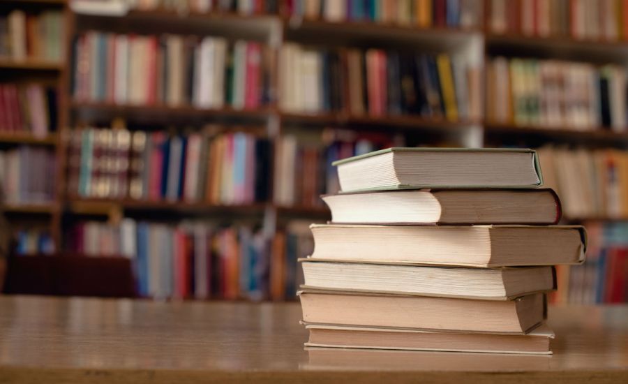 Photo of books on a table in a library