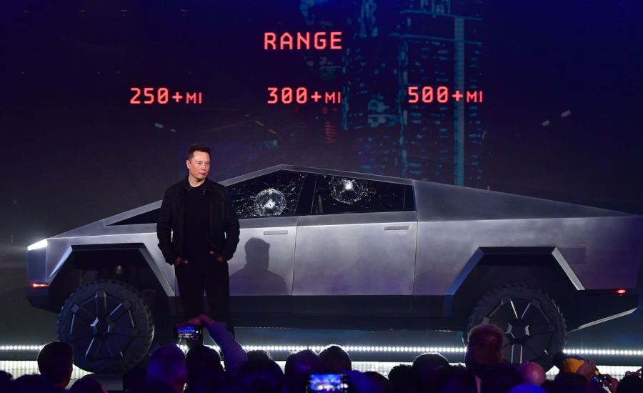 Elon Musk stands in front of Tesla's new electric Cybertruck pickup.