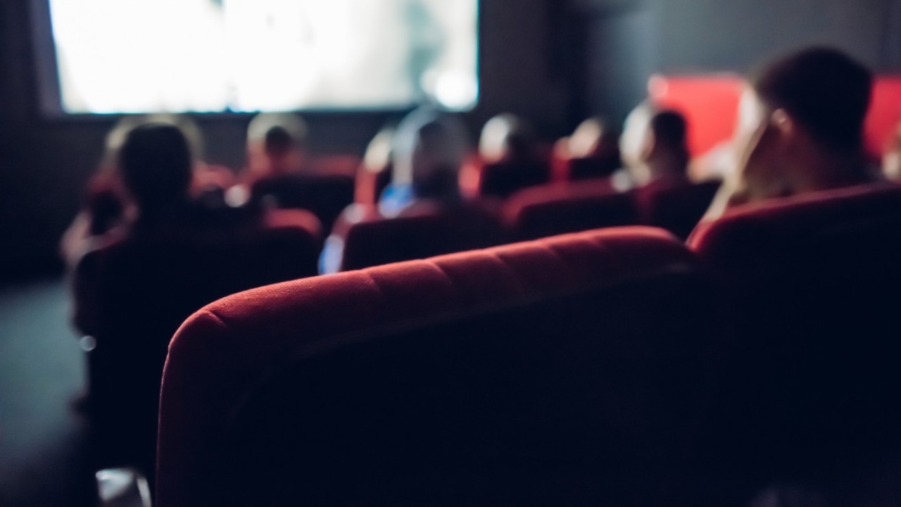 People sit in a small movie theater