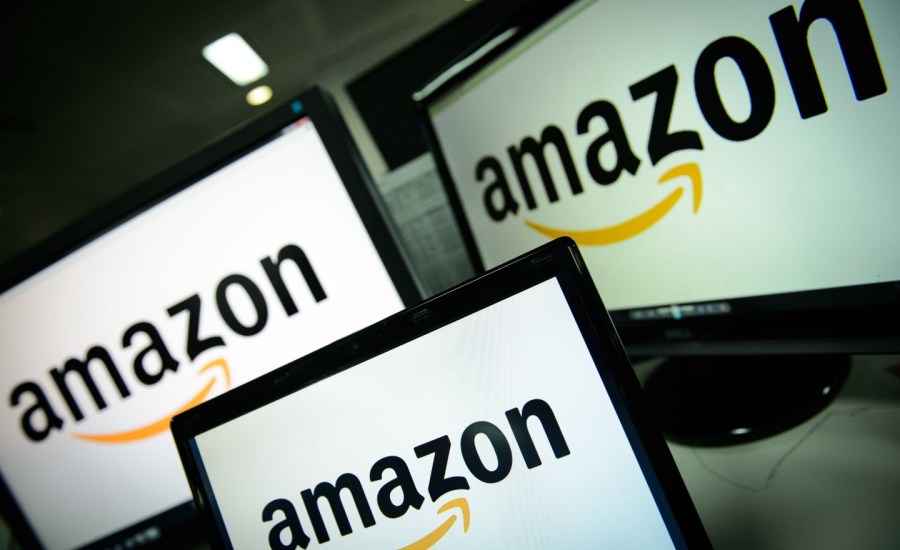 a photo of Amazon's logo displayed on three screens