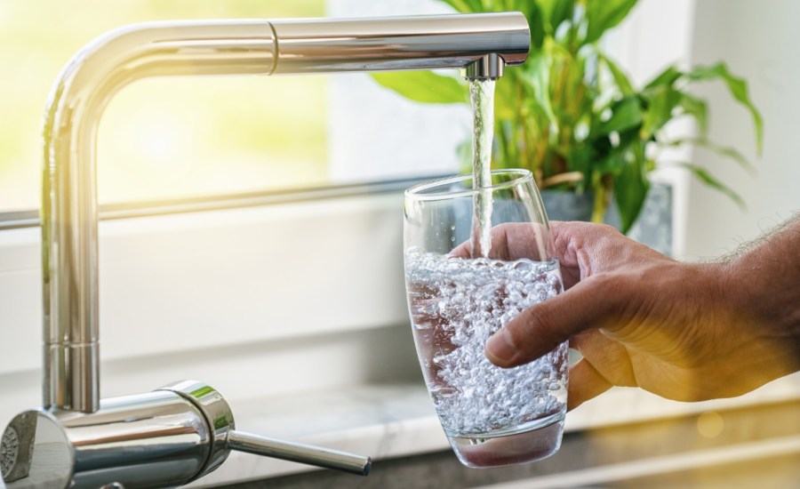 tap water being poured into a drinking glass