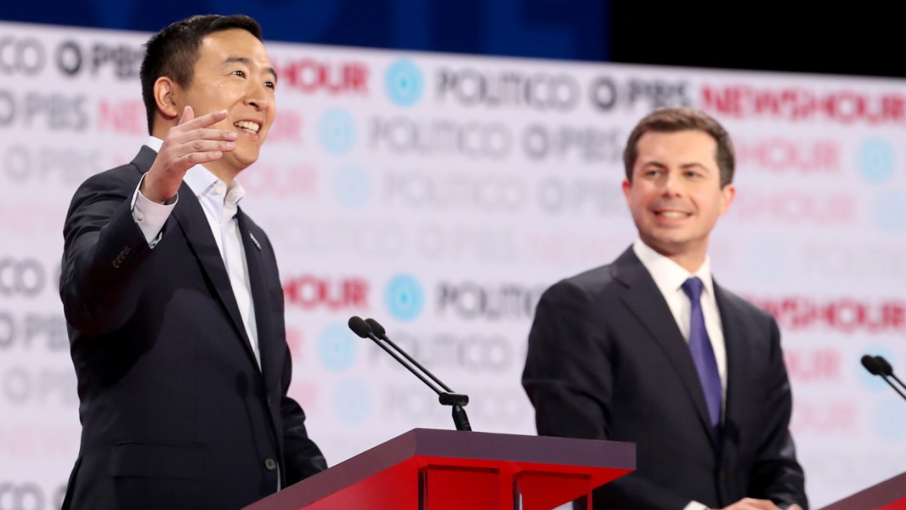 Democratic presidential candidates Andrew Yang and Pete Buttigieg stand on the debate stage