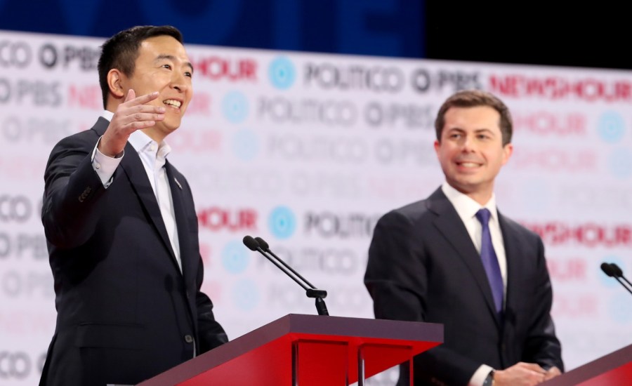 Democratic presidential candidates Andrew Yang and Pete Buttigieg stand on the debate stage