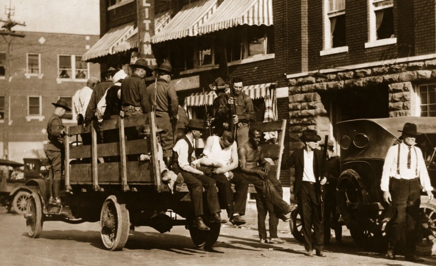 Injured and wounded prisoners are being taken to hospital by National guardsmen after the Tulsa race riots in 1921