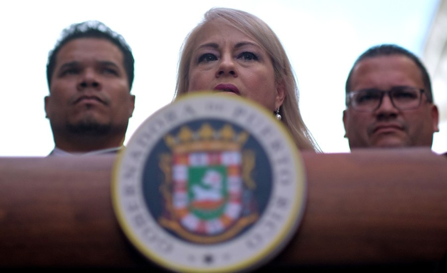 the governor of puerto rico wanda vazquez garced stands behind a podium