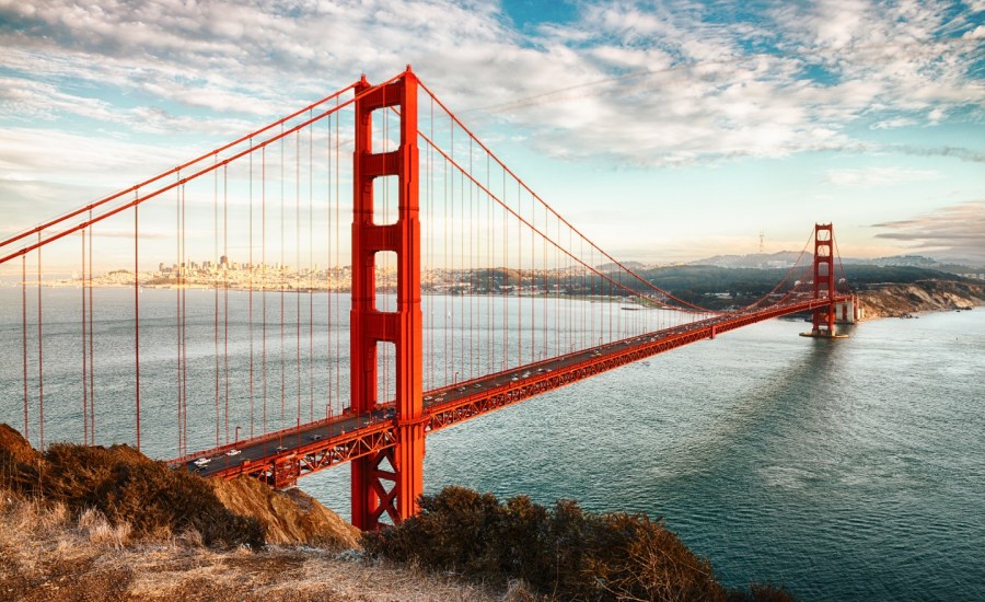 a view of the golden gate bridge with san francisco behind it, across a river