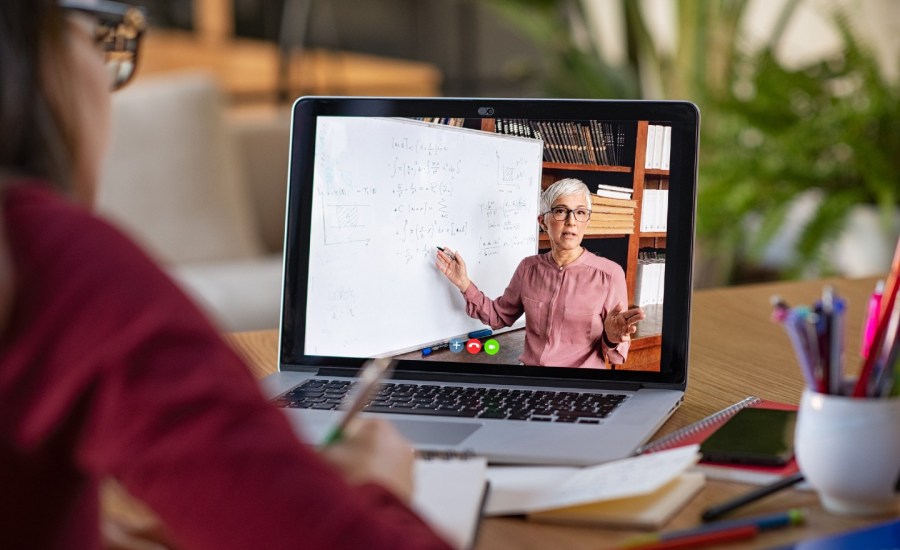 A student does a long distance learning lesson on her computer