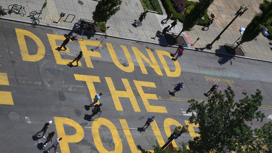 "Defund the Police" written in yellow on road