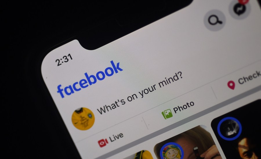 Facebook feed page is displayed on a smartphone