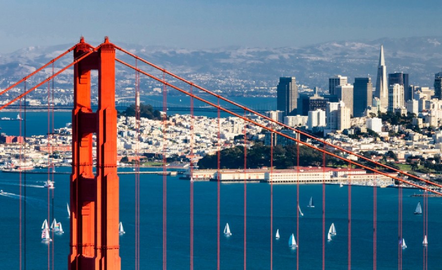 a view of san francisco over the river with the golden gate bridge in the forefront