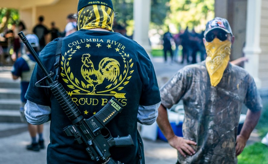 Armed members of the far-right Proud Boys groups stand guard during a memorial for Patriot Prayer member Aaron Jay Danielson