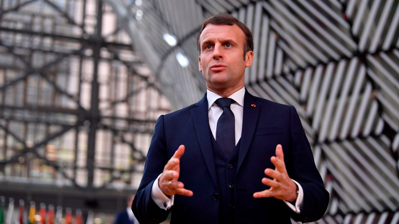 France's President Emmanuel Macron speaks to the press as he arrives at the EU headquarters' Europa building in Brussels on December 10, 2020, prior to a European Union summit