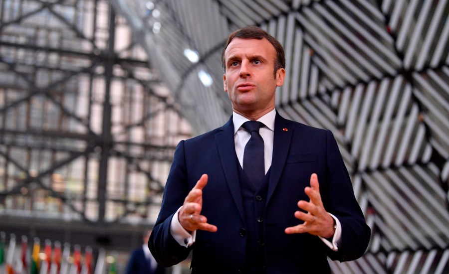 France's President Emmanuel Macron speaks to the press as he arrives at the EU headquarters' Europa building in Brussels on December 10, 2020, prior to a European Union summit