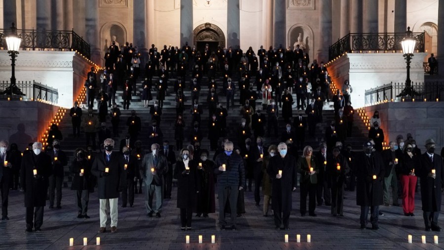 Lawmakers hold a candlelight vigil for the 500,000-plus people who have died from COVID-19 in the U.S.