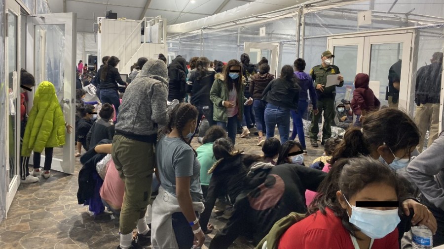 Migrants crowd a Border Patrol facility