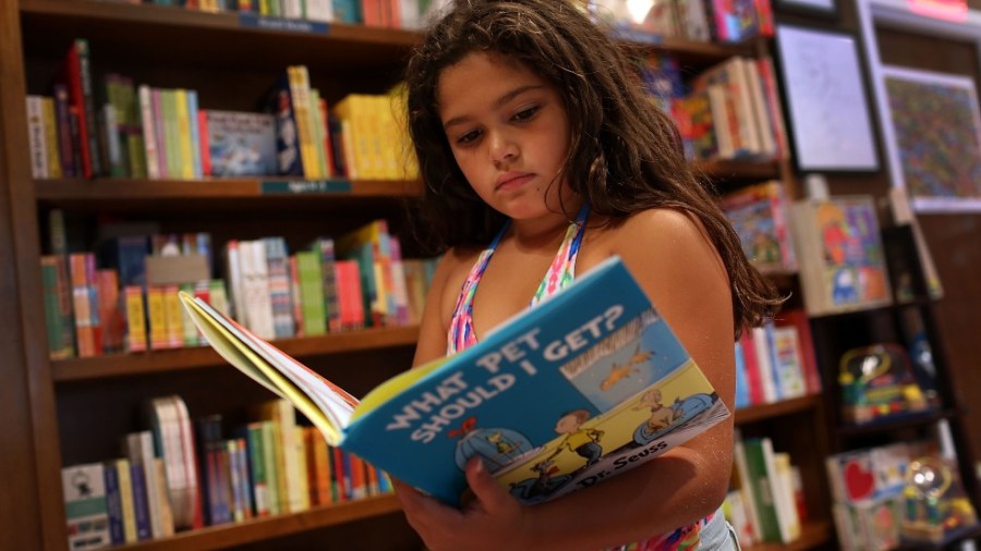 A child reads a Dr. Seuss book