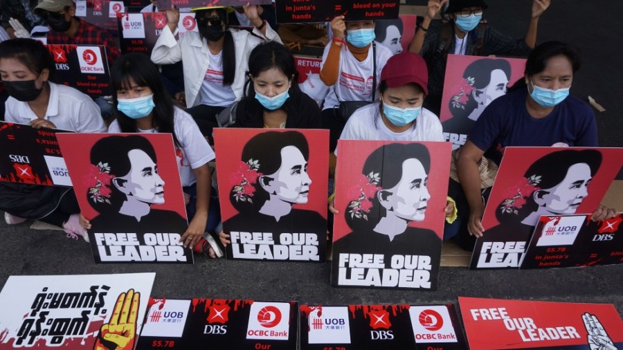 Protesters hold signs of detained Myanmar civilian leader Aung San Suu Kyi during a demonstration against the military coup in Yangon on February 26, 2021.