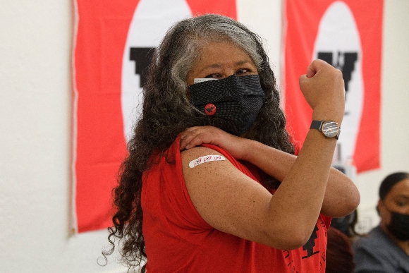 A woman poses after getting COVID-19 vaccine