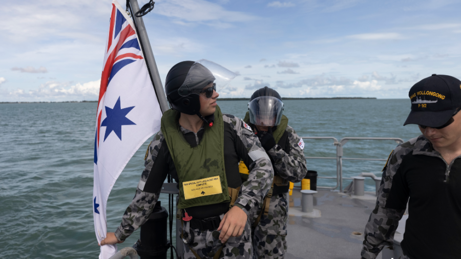 Royal Australian Navy officers are seen aboard the HMAS Wollongong in waters between Papua New Guinea and the Australian island of Saibai