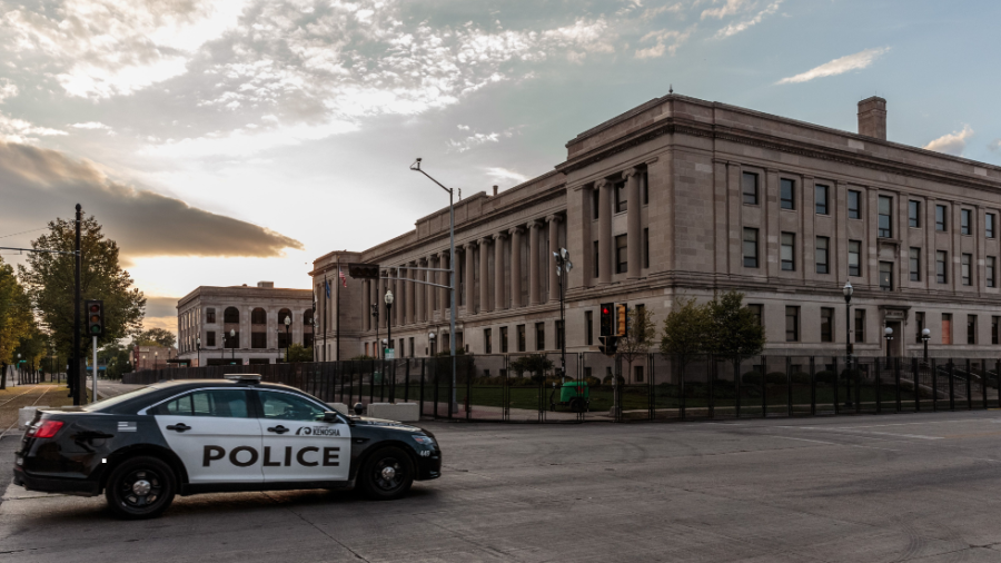 A Kenosha Police car drives past the Kenosha Courthouse