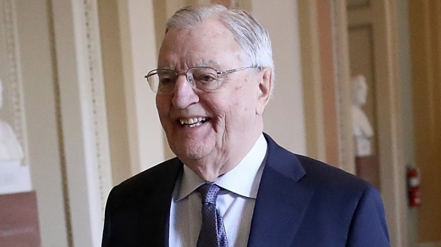 Former Vice President Walter Mondale walks outside the Senate chamber in 2018