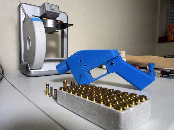 A Liberator pistol appears on July 11, 2013 next to the 3D printer on which its components were made.