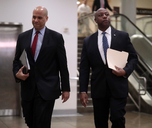 Sen. Cory Booker (D-NJ) (L) and Sen. Tim Scott (R-SC)