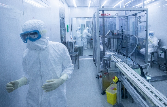 Employees work on the production line of CoronaVac