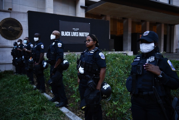 Police officers line up by the AFL-CIO building