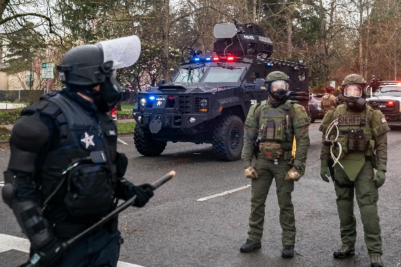 Marion Country Sheriff's deputies and Oregon State Troopers disperse a crowd of protesters in Salem