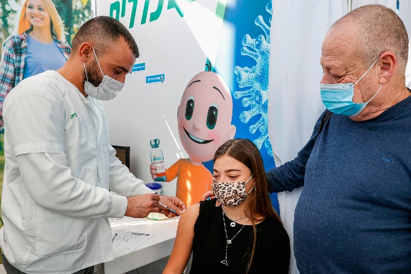 A teen receives a COVID-19 vaccine