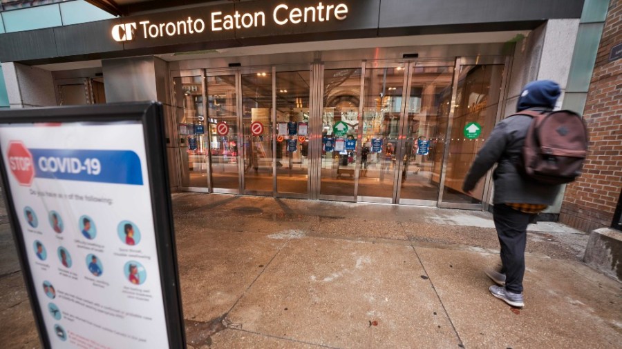 A man arrives at the entrance to the Toronto Eaton Centre in downtown Toronto, Ontario