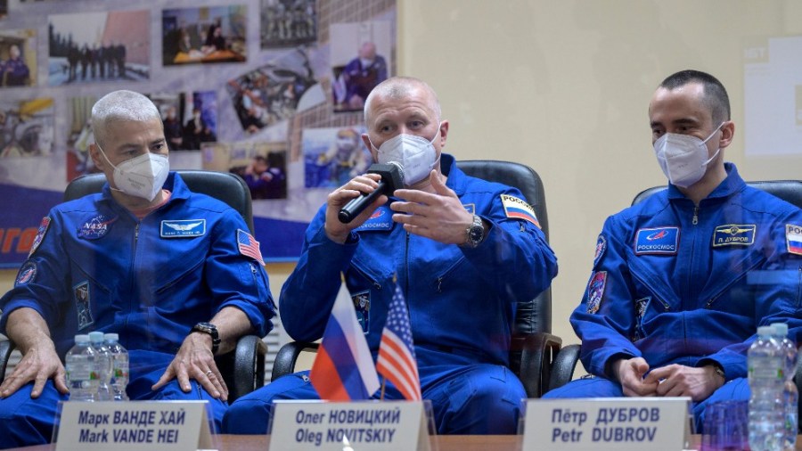 NASA astronaut Mark Vande Hei, from left, and Russian cosmonauts Oleg Novitskiy and Pyotr Dubrov hold a press conference