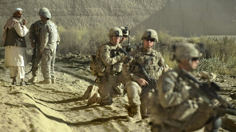 An elderly Afghani man is questioned by U.S. Army soldiers through an interpreter in 2012