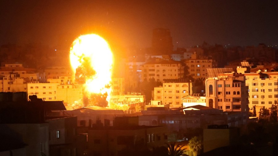 Fire and smoke rise above buildings in Gaza City as Israeli warplanes target the Palestinian enclave