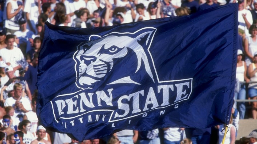 Penn State Nittany Lion fans hoist a flag up in the air during a game against the Southern Mississippi State Golden Eagles at the Beaver Stadium