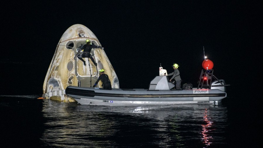 Support teams work around the SpaceX Crew Dragon Resilience spacecraft