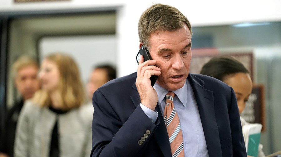 Sen. Mark Warner (D-Va.) arrives to the Capitol for a series of votes on May 27