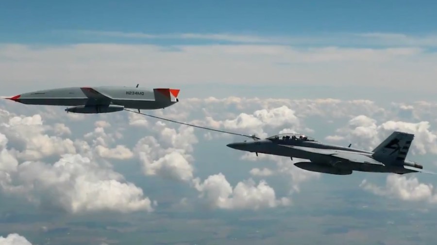 A drone refuels a Navy F/A-18 Super Hornet for the first time