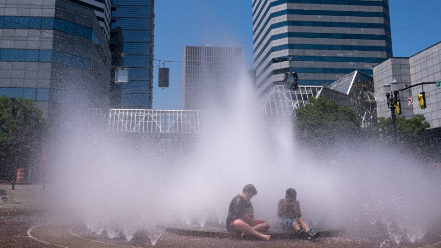 Children play in the Salmon Springs Fountain in Portland, Ore. amid a record-setting heat wave