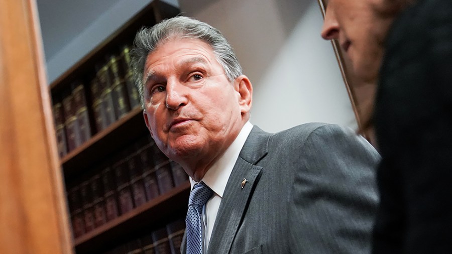 Sen. Joe Manchin (D-W.Va.) speaks to reporters as he arrives for a Senate Energy and Natural Resources Committee hearing on June 8