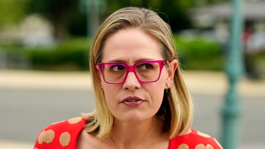 Sen. Kirsten Sinema (D-Ariz.) speaks to reporters as she arrives at the Capitol for a nomination vote on June 21