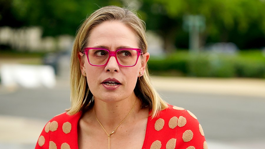 Sen. Kirsten Sinema (D-Ariz.) speaks to reporters as she arrives at the Capitol for a nomination vote on June 21