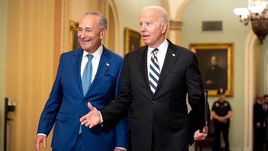 Majority Leader Charles Schumer (D-N.Y.) leads President Biden as he arrives to the Capitol for a luncheon with Senate Democrats to discuss an infrastructure plan on Wednesday, July 14, 2021.