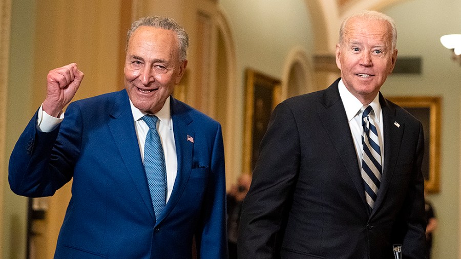 Majority Leader Charles Schumer (D-N.Y.) leads President Biden as he arrives to the Capitol for a luncheon with Senate Democrats to discuss an infrastructure plan on Wednesday, July 14, 2021.