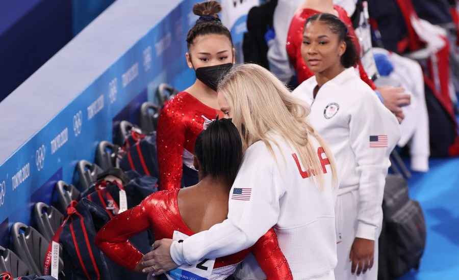 Simone Biles of Team United States is hugged by coach Cecile Landi after stumbling on vault during the Women's Team Final on day four of the Tokyo 2020 Olympic Games at Ariake Gymnastics Centre on July 27, 2021 in Tokyo, Japan.