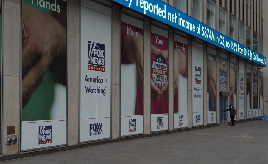 Manhattan, New York. October 22, 2020. Security man wearing a mask enters FOX News headquarters in midtown.