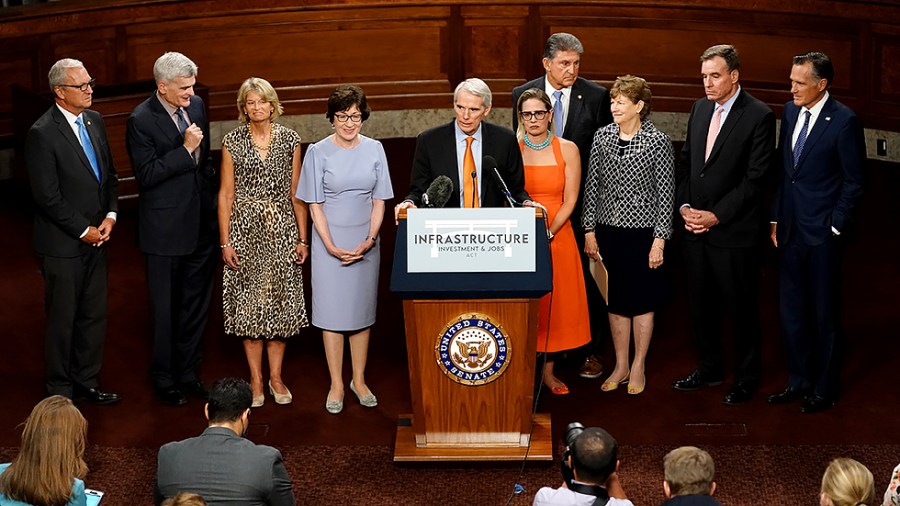 Members of the bipartisan infrastructure group addresses reporter after a key vote on Wednesday, July 28, 2021.