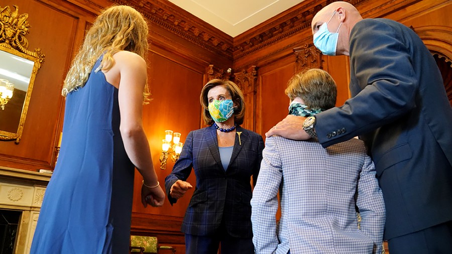 Speaker Nancy Pelosi (D-Calif.) speaks to the family of Rep. Jake Ellzey (R-Texas) before a ceremonial swearing in for press on Friday, July 30, 2021 after being sworn in at the House Chamber.